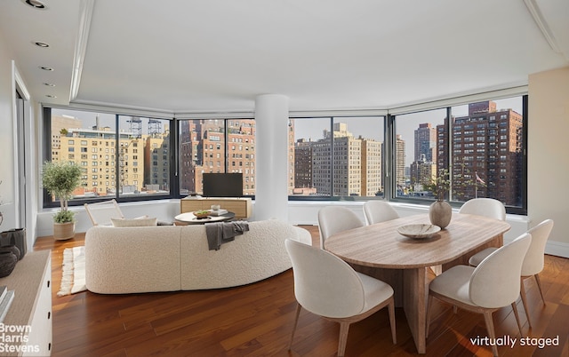 dining area featuring a wall of windows and hardwood / wood-style floors