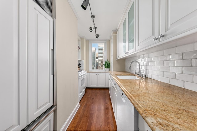 kitchen with white cabinets, track lighting, sink, and white appliances