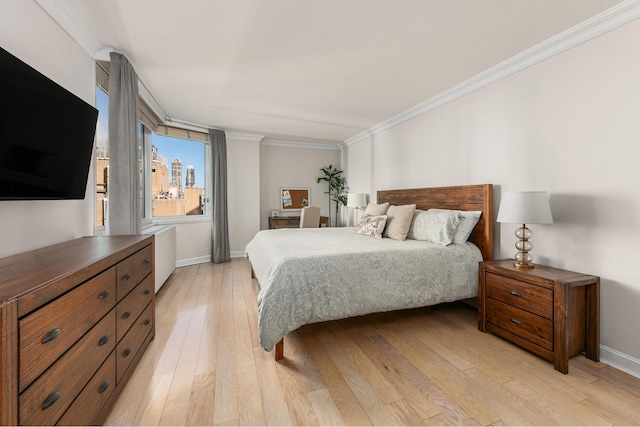 bedroom featuring light wood-type flooring and ornamental molding