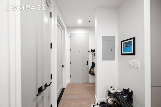 corridor featuring electric panel and light wood-type flooring