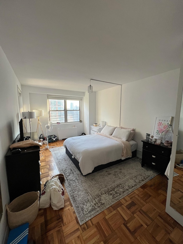 bedroom featuring dark parquet floors