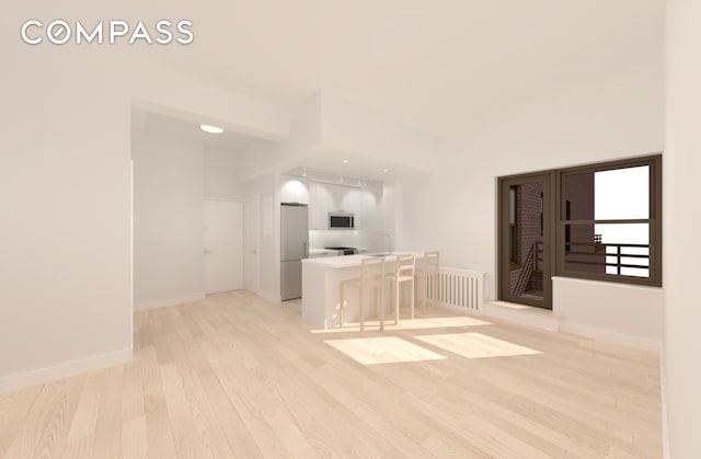 unfurnished living room featuring light wood-type flooring