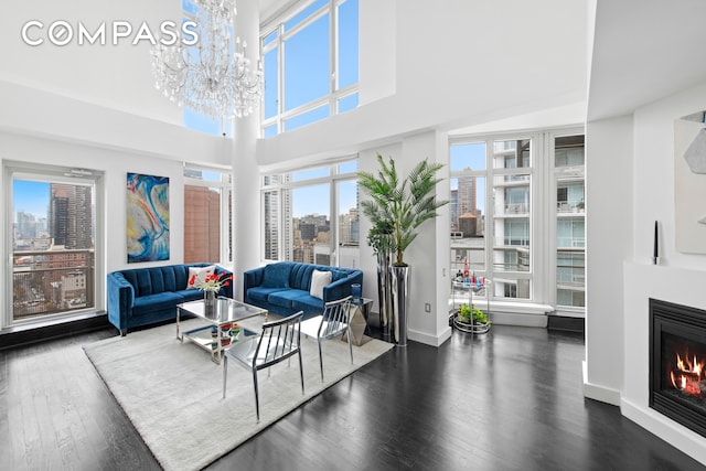 living room featuring an inviting chandelier and dark wood-type flooring