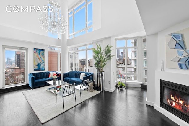 living room with a chandelier and dark wood-type flooring