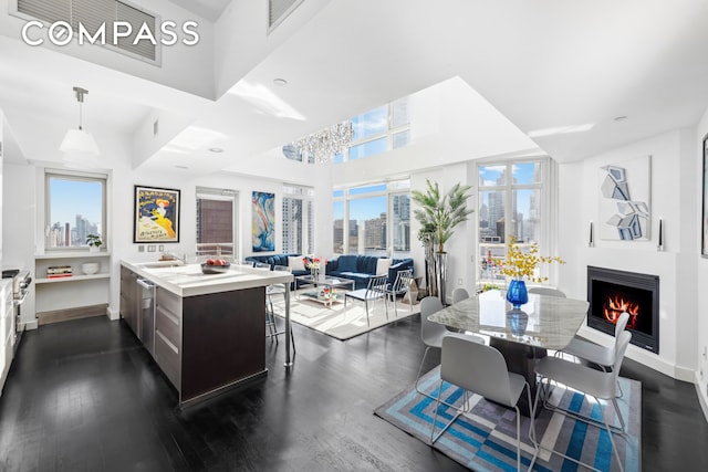 kitchen with a center island, dark hardwood / wood-style flooring, hanging light fixtures, and a wealth of natural light