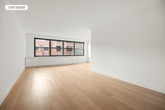 unfurnished room featuring light hardwood / wood-style flooring and radiator heating unit