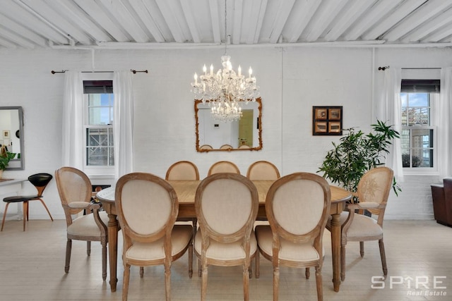 dining space featuring a chandelier, light hardwood / wood-style floors, and a healthy amount of sunlight