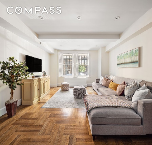 living room with beamed ceiling and light parquet floors