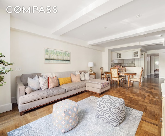 living room featuring beamed ceiling and dark parquet flooring