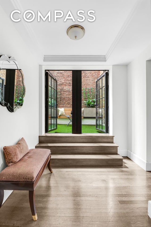 unfurnished room featuring wood-type flooring and crown molding