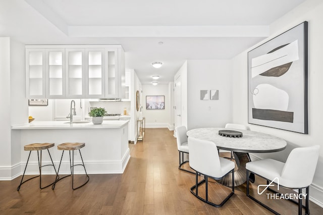 dining space featuring dark hardwood / wood-style floors and sink