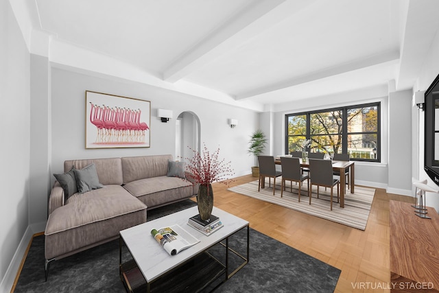 living room with beamed ceiling and parquet floors