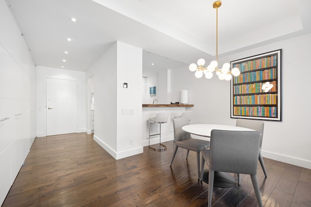 dining room featuring dark hardwood / wood-style floors and an inviting chandelier