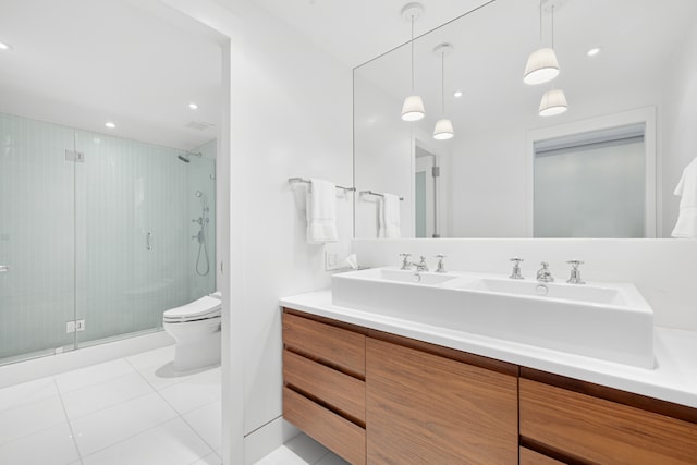 bathroom with tile patterned floors, vanity, toilet, and walk in shower