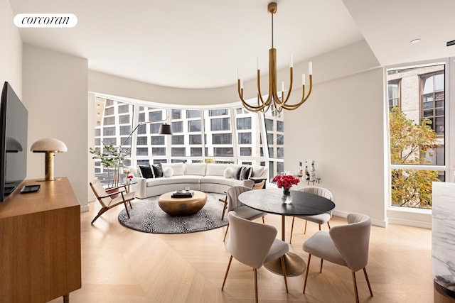 dining area with a chandelier and light hardwood / wood-style flooring