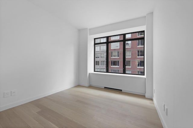 spare room with light wood-type flooring