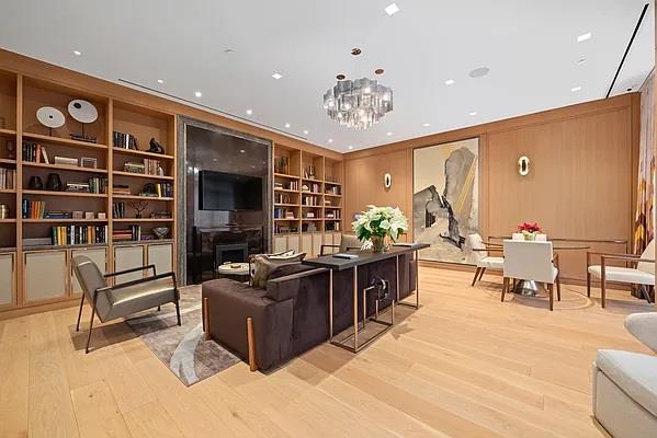 living room featuring built in shelves, light hardwood / wood-style floors, and a chandelier