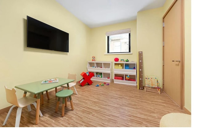 recreation room featuring light wood-type flooring