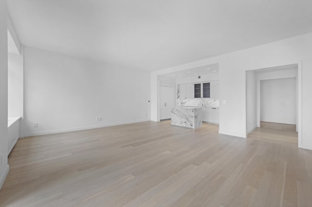 unfurnished living room with light wood-type flooring