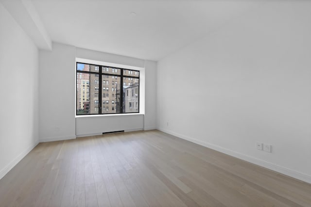 spare room with light wood-type flooring