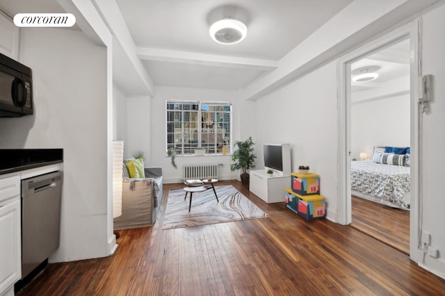 living room featuring radiator heating unit and dark hardwood / wood-style floors