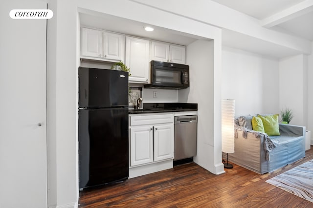 kitchen with dark wood-type flooring, white cabinets, sink, and black appliances