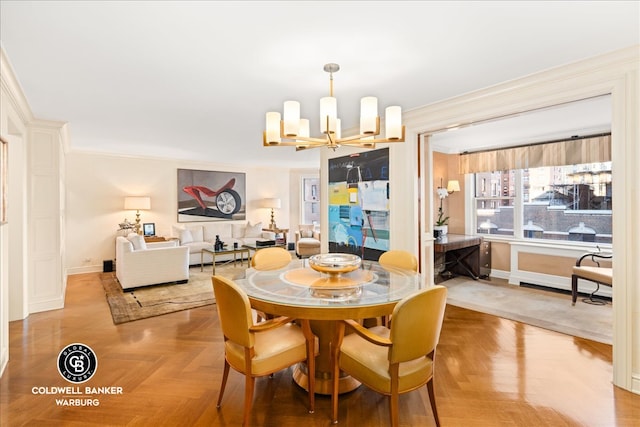 dining room with a chandelier, parquet floors, and crown molding