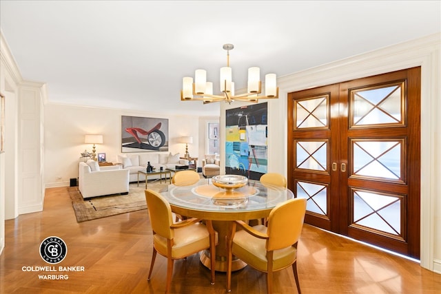 dining room with french doors, parquet flooring, crown molding, and an inviting chandelier