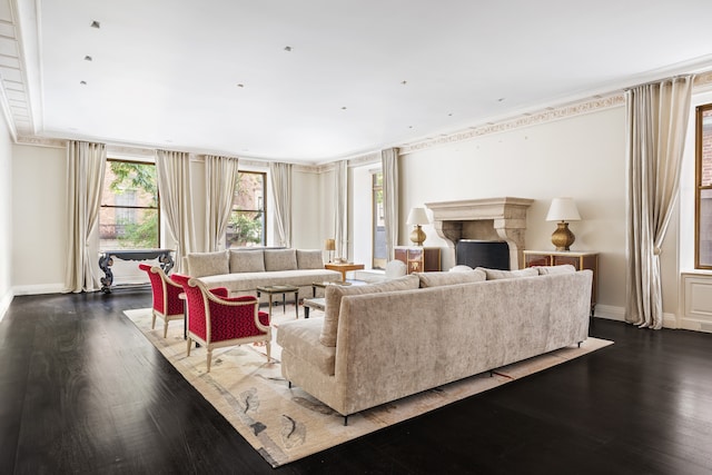 living room with dark wood-type flooring and crown molding