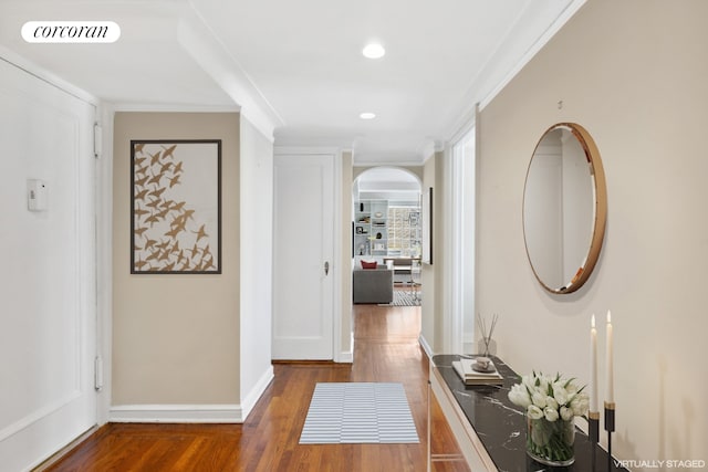 hallway with ornamental molding and dark hardwood / wood-style floors