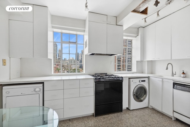 kitchen featuring dishwasher, sink, black range, white cabinetry, and washer / clothes dryer