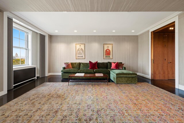 living room featuring ornamental molding and dark hardwood / wood-style flooring