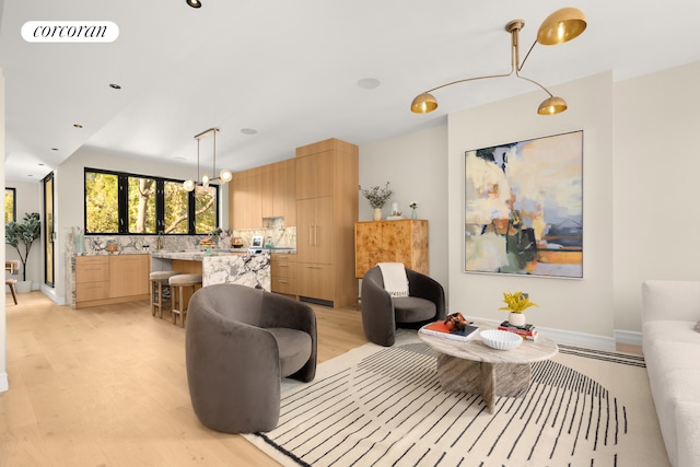 living room featuring light hardwood / wood-style floors and a chandelier