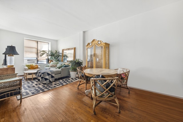 dining space featuring cooling unit and hardwood / wood-style flooring