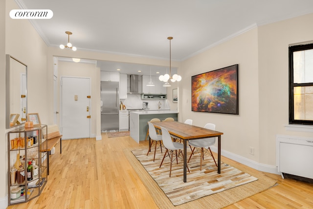 dining space featuring a chandelier, radiator heating unit, light wood-type flooring, and ornamental molding