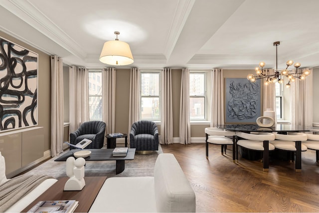 living room with a chandelier, dark parquet floors, a tray ceiling, and ornamental molding