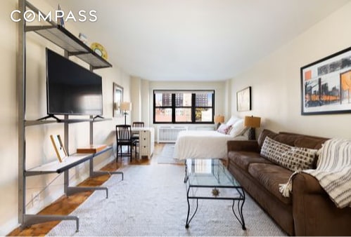 bedroom with radiator heating unit and hardwood / wood-style flooring