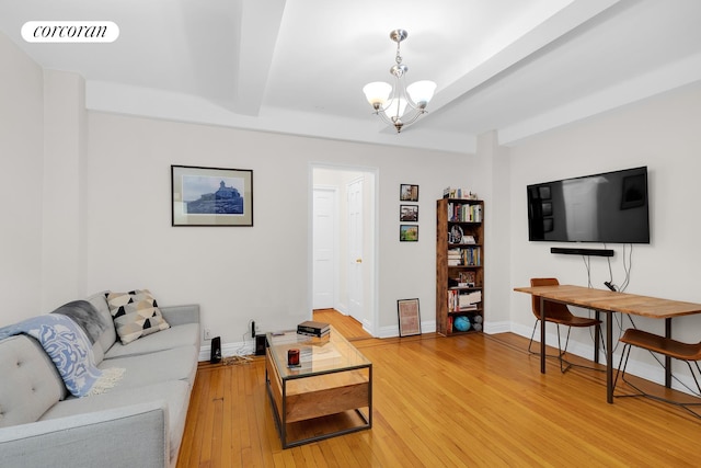 living room with wood-type flooring and an inviting chandelier