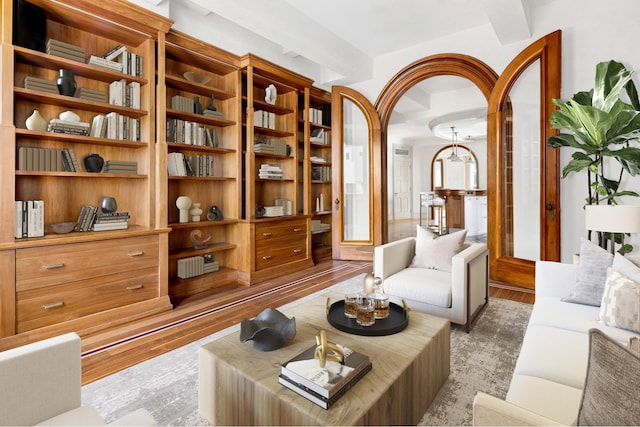 sitting room with beam ceiling and light hardwood / wood-style floors