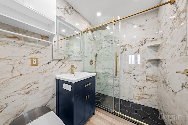 bathroom featuring vanity, tile walls, and walk in shower