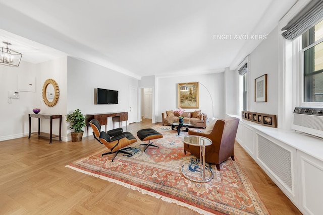 living room featuring light parquet floors and a notable chandelier