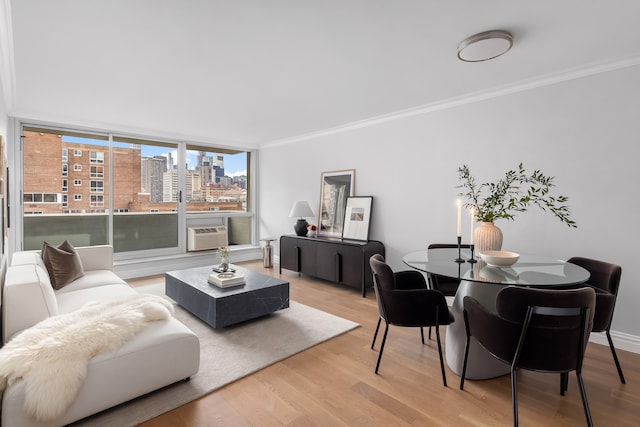 living room featuring hardwood / wood-style flooring, ornamental molding, and an AC wall unit