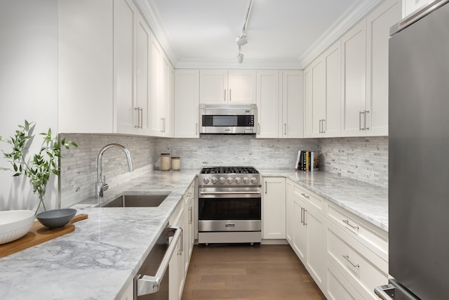 kitchen featuring appliances with stainless steel finishes, dark hardwood / wood-style flooring, light stone counters, sink, and white cabinets