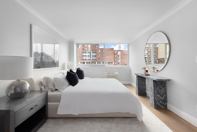 bedroom with light hardwood / wood-style floors and ornamental molding