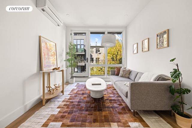 living room featuring a wall mounted air conditioner and wood-type flooring