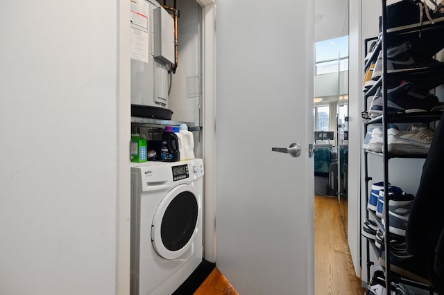 laundry area featuring washer / clothes dryer and light wood-type flooring