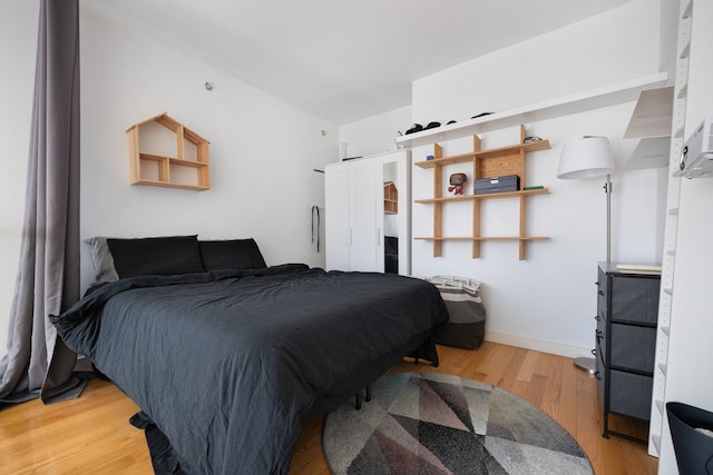 bedroom with wood-type flooring