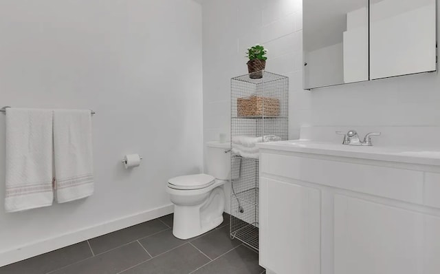 bathroom with tile patterned floors, vanity, and toilet