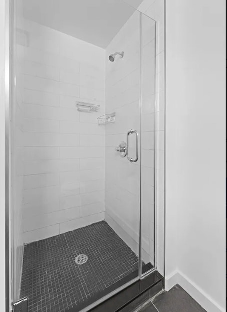 bathroom with a shower with shower door