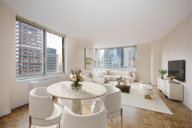 dining area featuring a wealth of natural light and light parquet floors